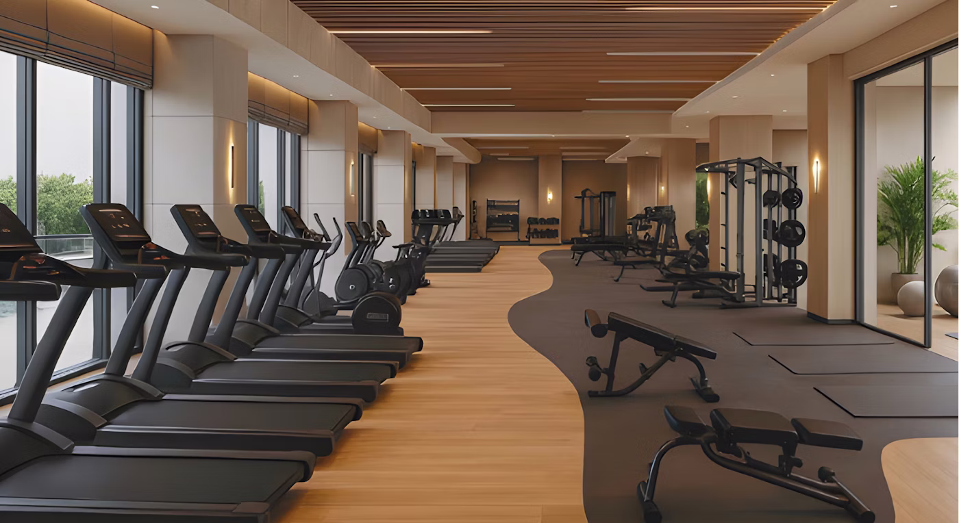 Modern gym with treadmills and weight machines.
